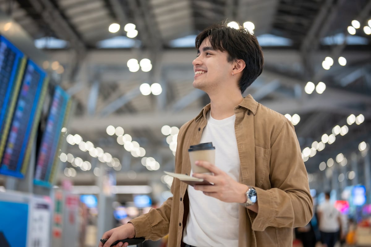 Foreign worker walking through an airport terminal toward the boarding gate